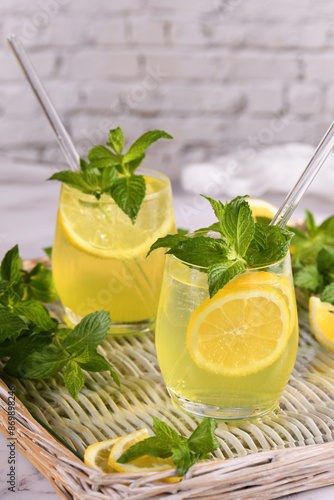 The Limoncello Spritz is a light, refreshing, cool cocktail made with lemon liqueur, prosecco and sparkling water, mint and a slice of lemon. photo