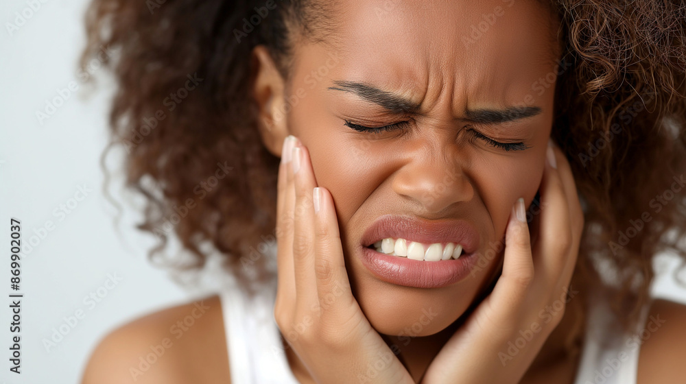 A woman suffers from tooth sharp pain and headache and puts her hand on her cheek . A woman suffers from severe toothache A woman suffers from tooth sharp pain and headache and puts her hand on her cheek . A woman suffers from severe toothache