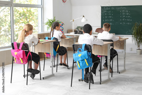 Little classmates sitting a...