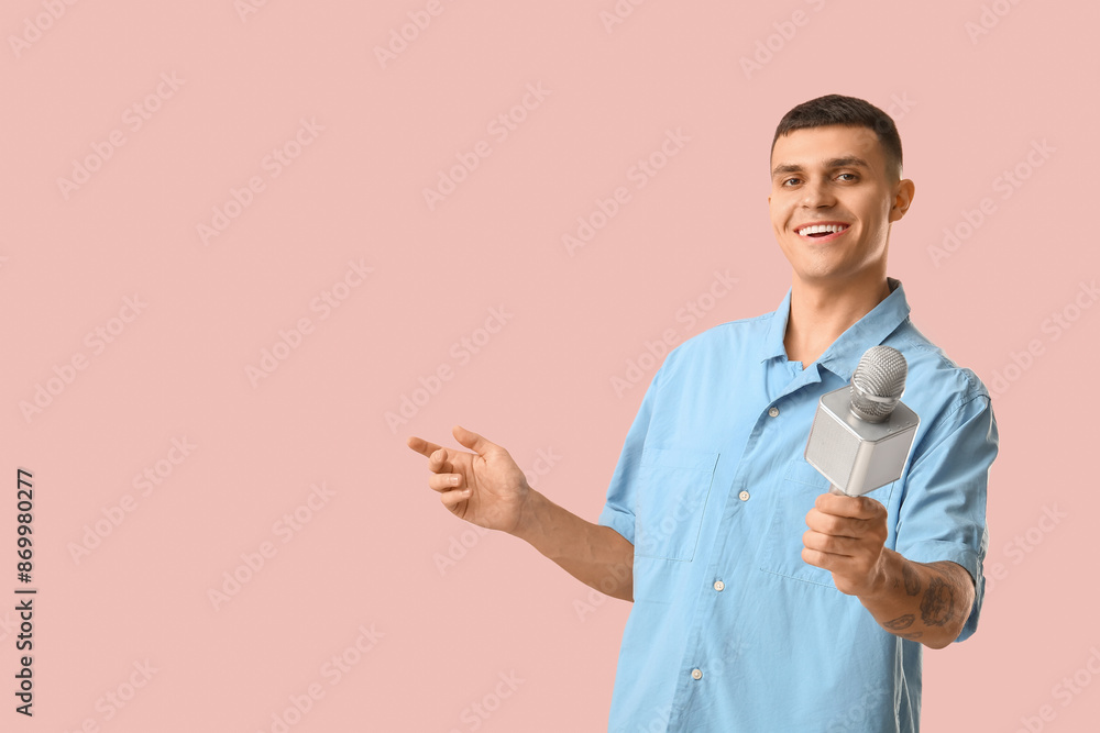 Young man with microphone on pink background Young man with microphone on pink background