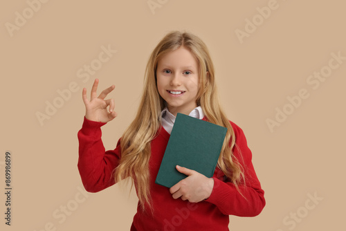 Smiling young schoolgirl ho...