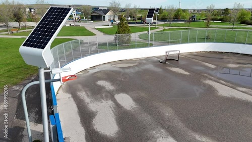 Airdrie Alberta Canada, May 21 2024: Solar panel charging lights for basketball court and hockey rink close up aerial shot.
 photo