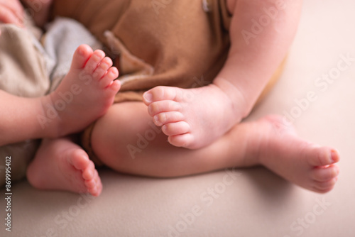 Little newborn baby human feet with toes and toenails close up