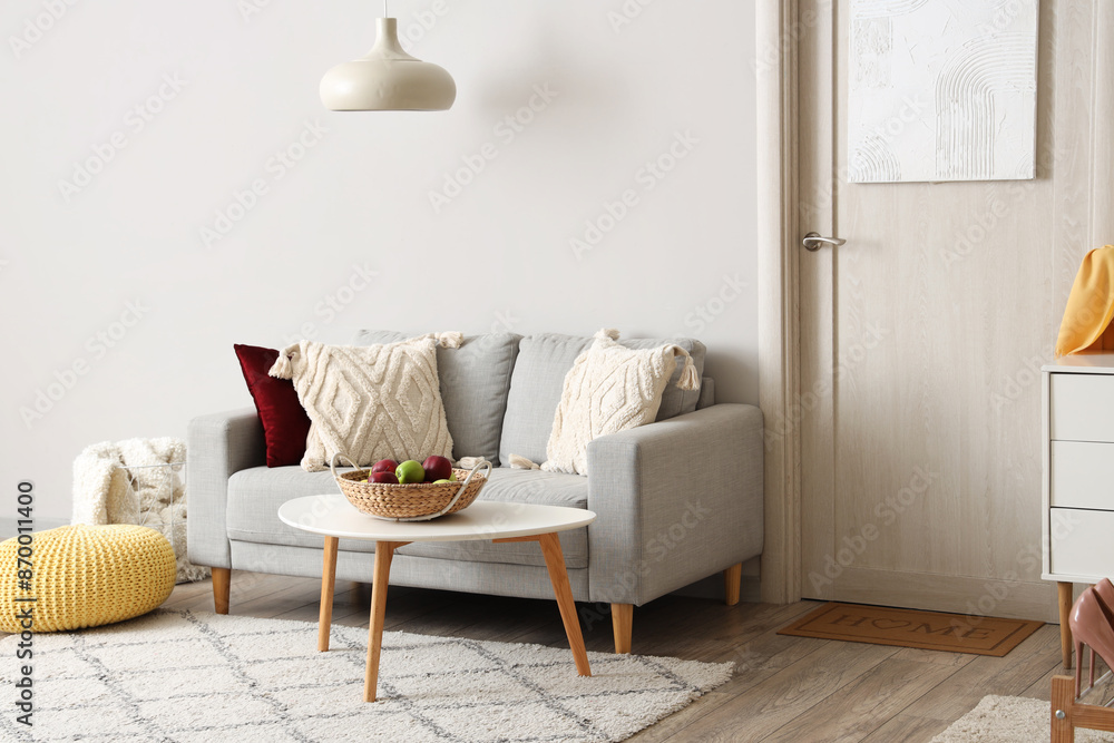 Obraz premium Stylish interior of hall with cozy sofa, chest of drawers and door