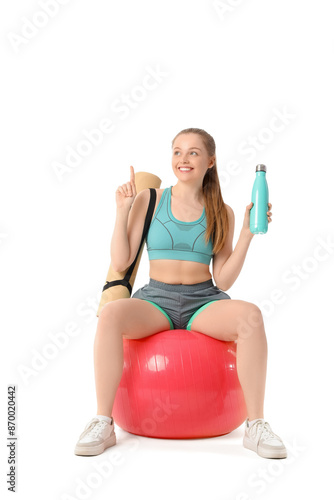 Sporty young woman with mat...