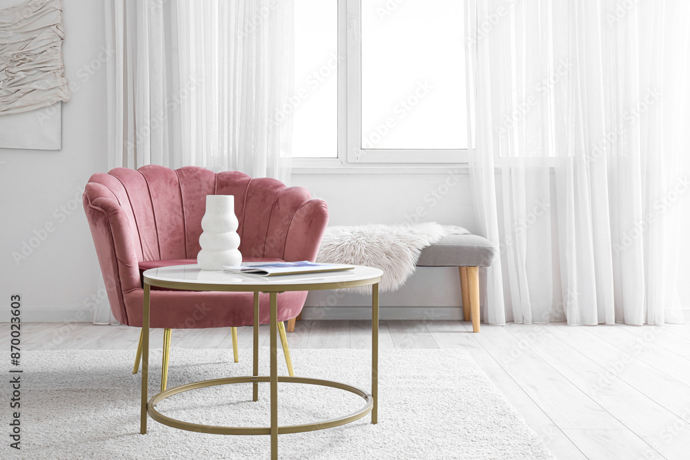 Armchair and coffee table with vase and magazine in living room Armchair and coffee table with vase and magazine in living room