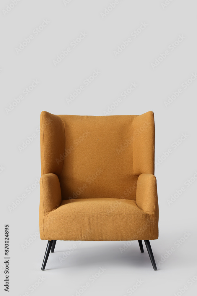 Comfortable brown armchair on grey background Comfortable brown armchair on grey background