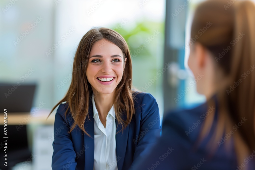 Fototapeta premium Smiling Female Manager Interviewing an Applicant In Office