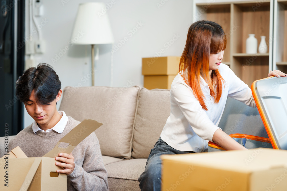 Young women, men, and Asian people prepare for moving into a new home. From unpacking supplies to updating documents, follow a comprehensive checklist in the living room with a big cardboard box. Young women, men, and Asian people prepare for moving into a new home. From unpacking supplies to updating documents, follow a comprehensive checklist in the living room with a big cardboard box.