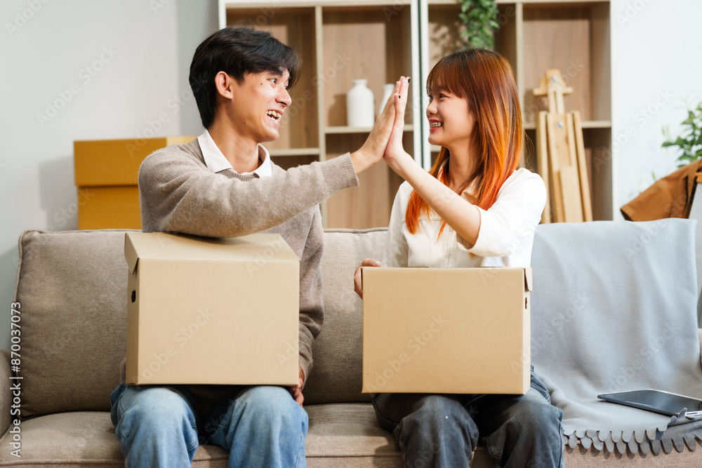 Young women, men, and Asian people prepare for moving into a new home. From unpacking supplies to updating documents, follow a comprehensive checklist in the living room with a big cardboard box. Young women, men, and Asian people prepare for moving into a new home. From unpacking supplies to updating documents, follow a comprehensive checklist in the living room with a big cardboard box.