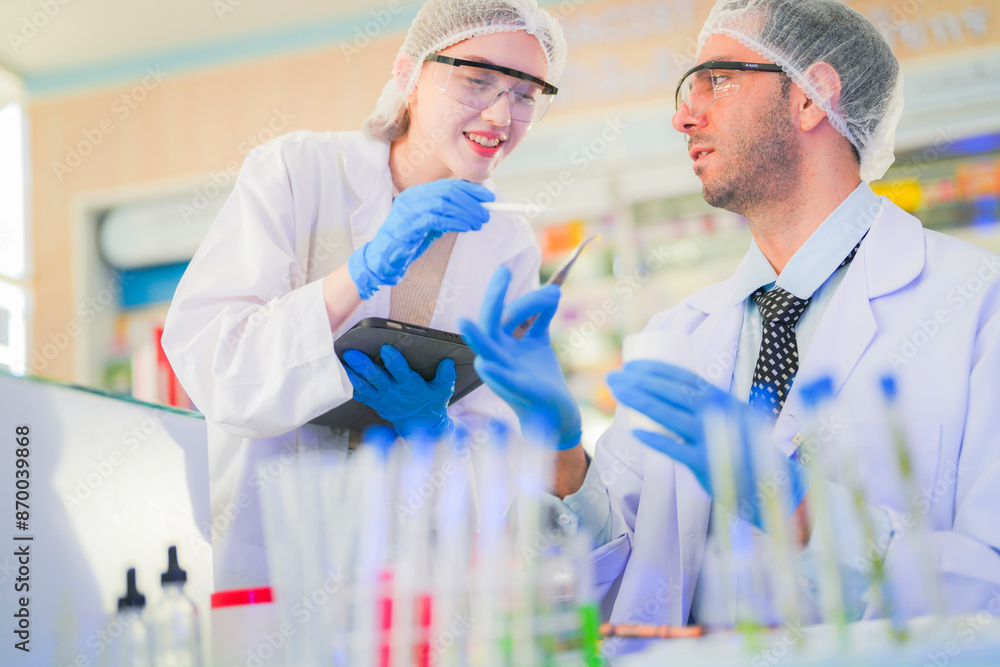 scientists perform experiments and record data. people arranges equipment with test tubes and chemicals for producing medicine and biochemistry. man hold tubes of chemical liquids and plant samples. scientists perform experiments and record data. people arranges equipment with test tubes and chemicals for producing medicine and biochemistry. man hold tubes of chemical liquids and plant samples.