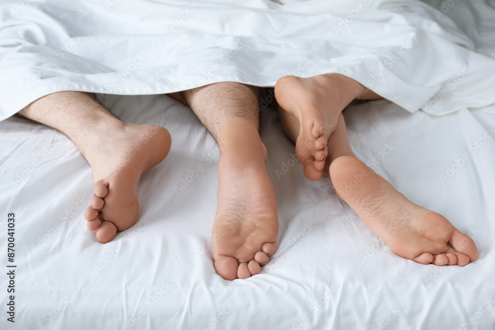 Lovely couple lying in bed at home, closeup view Lovely couple lying in bed at home, closeup view