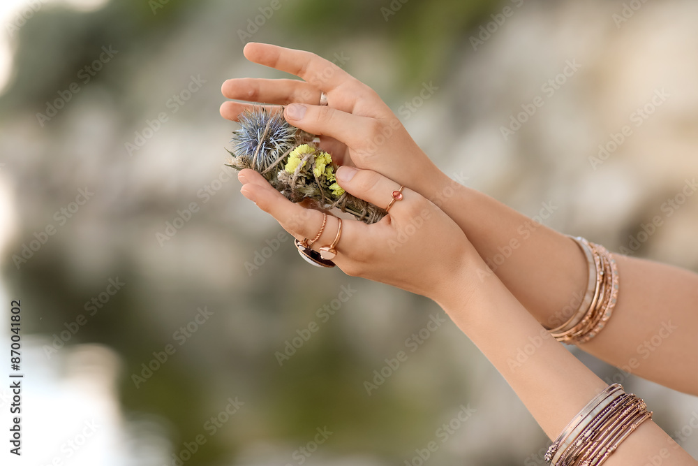 Obraz premium Hands of young female shaman with herbs outdoors