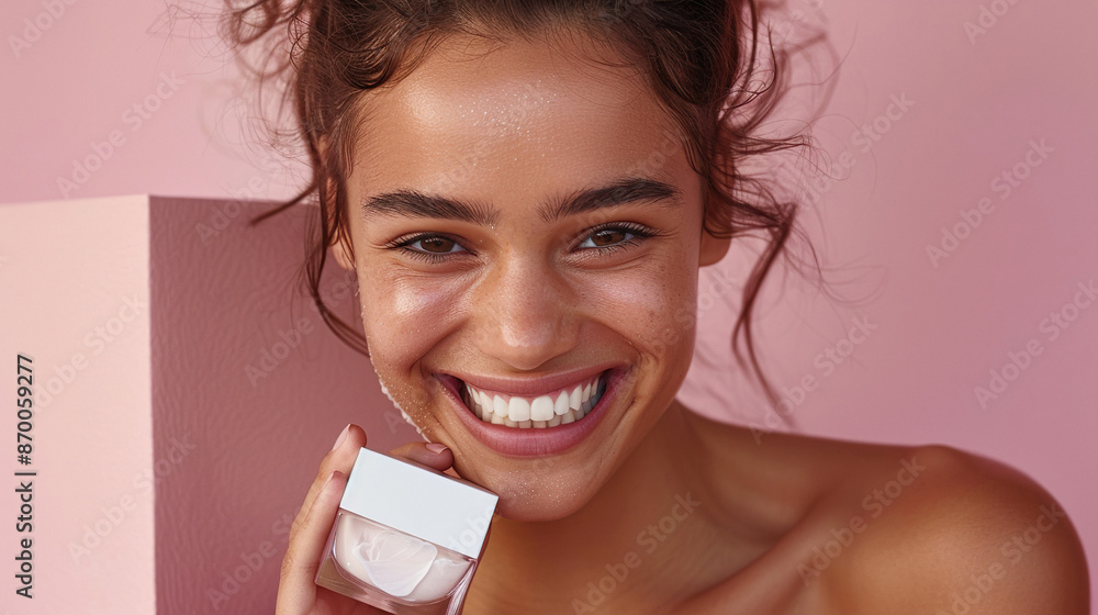 Attractive woman holds in hand a tube of cream close to her face showcasing the product Attractive woman holds in hand a tube of cream close to her face showcasing the product