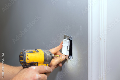 An electrician replace at outlet in house during reconstruction