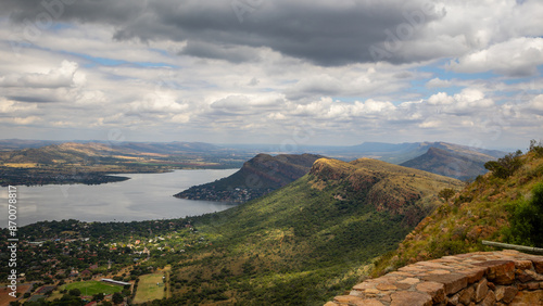 Cuestas, landforms of tilted rock layers or strata, on the north shore of Hartbeespoort dam under a cloudy sky in the Magaliesberg mountain range in North West province in South Africa. photo