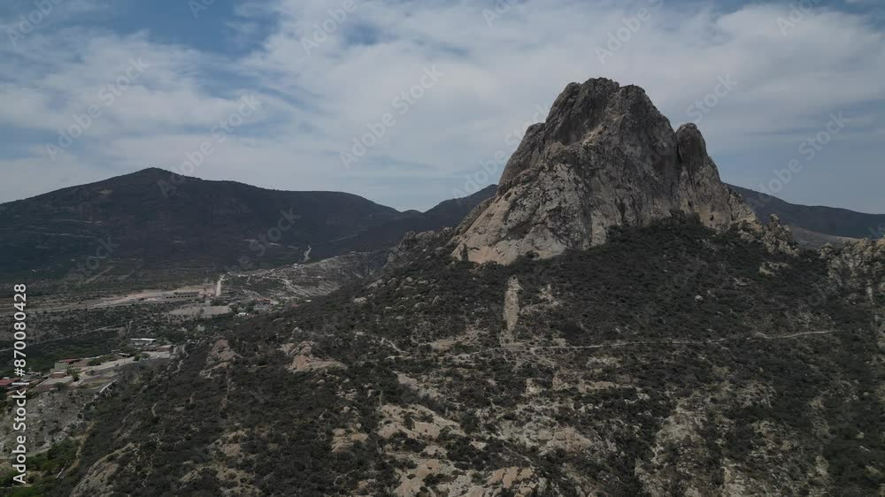 Majestic Pena De Bernal mountain rock formation inQueretaro town below in Mexico. Majestic Pena De Bernal mountain rock formation inQueretaro town below in Mexico.
