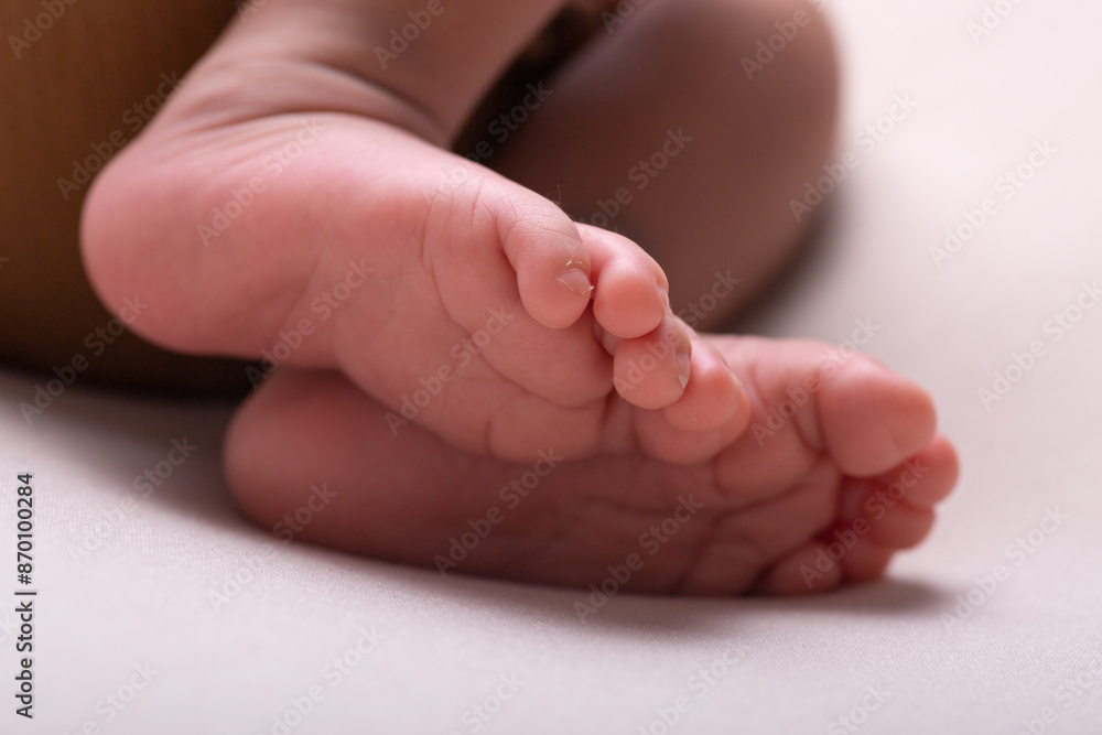 Little newborn baby human feet with toes and toenails close up Little newborn baby human feet with toes and toenails close up