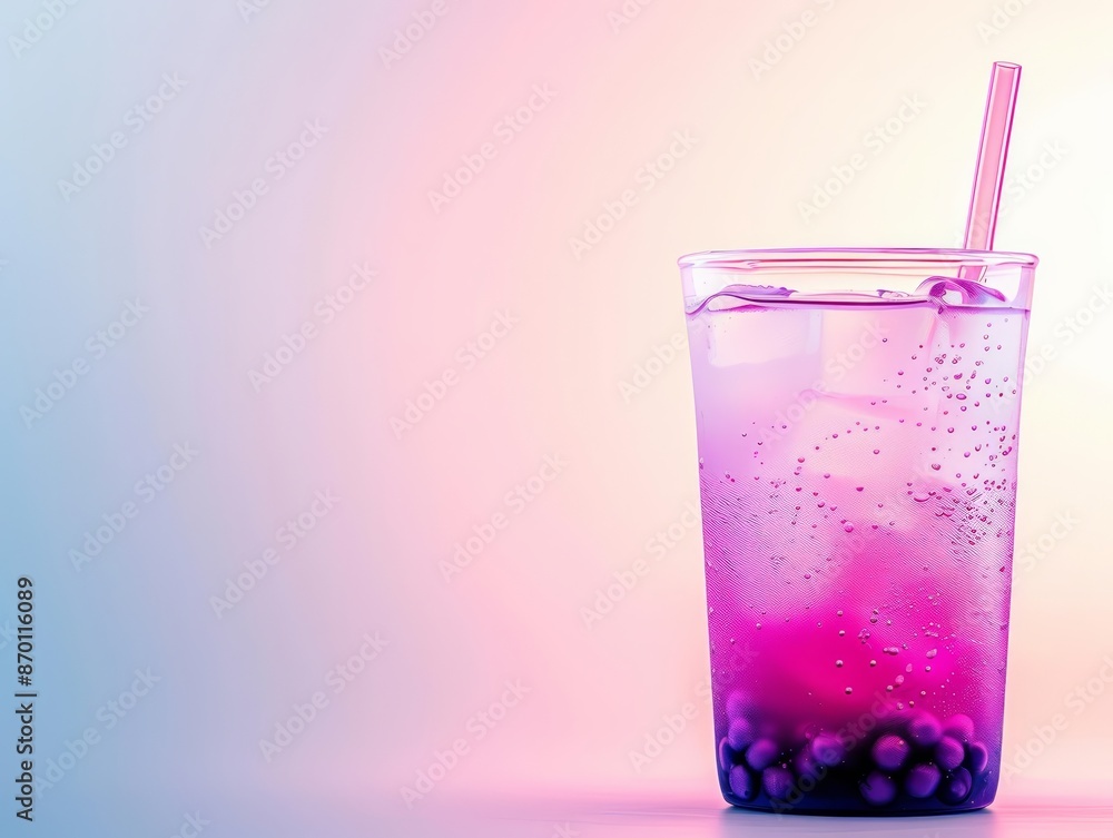 Refreshing beverage with tapioca pearls in a clear glass against a pink and blue gradient background, perfect for summer. Refreshing beverage with tapioca pearls in a clear glass against a pink and blue gradient background, perfect for summer.