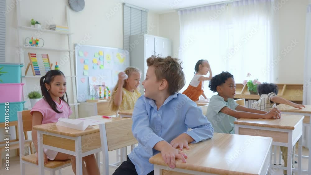 Diversity young student throws a lump of paper in classroom at school. Diversity young student throws a lump of paper in classroom at school.