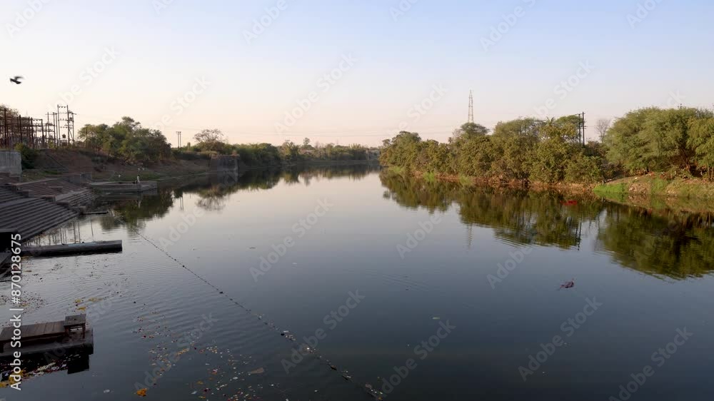 calm river with green forest at shore at morning from flat angle calm river with green forest at shore at morning from flat angle