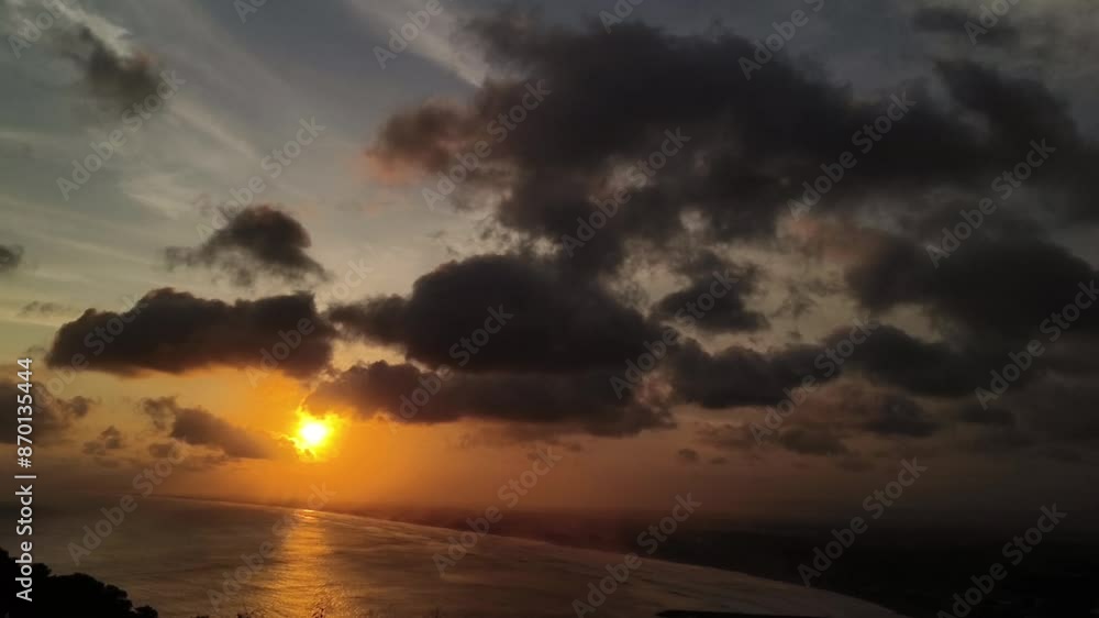 Warm sunset light and dark clouds reflect on water. Evening Sky. Sky Twilight, Dusk Backgrounds Warm sunset light and dark clouds reflect on water. Evening Sky. Sky Twilight, Dusk Backgrounds