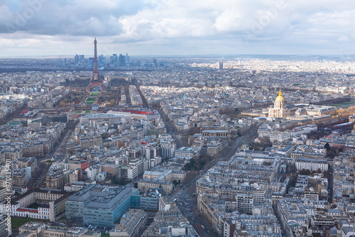 City of Paris is shown from above, with the Eiffel Tower visible in the distance. The city is bustling with activity, with cars and people moving about on the streets