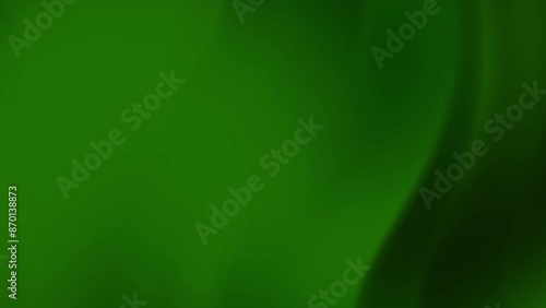 Dark green gradient background with out of focus green leaf, light reflecting. Suitable for nature, abstract, background, and organic themes in design projects or marketing materials.