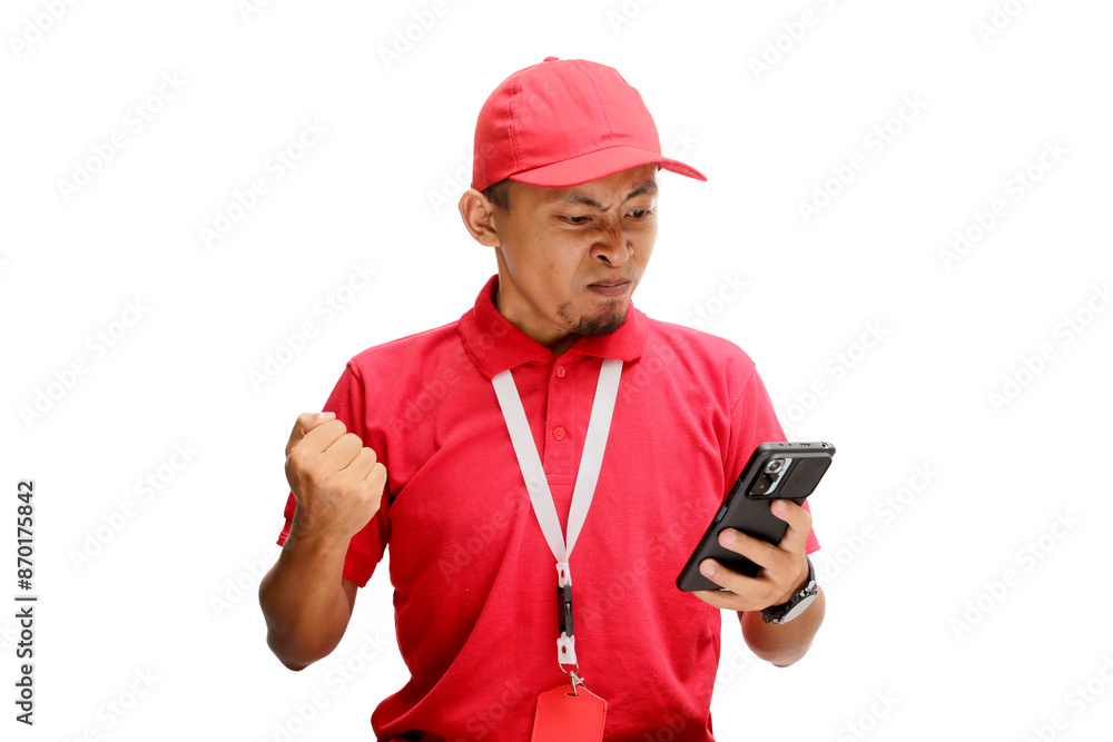 An upset Asian delivery man or courier reacting angrily to bad news, delay, or shipment problems on his smartphone. Isolated on a white background An upset Asian delivery man or courier reacting angrily to bad news, delay, or shipment problems on his smartphone. Isolated on a white background
