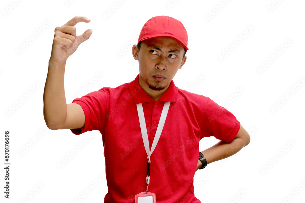 Asian delivery man is gesturing a small size with his finger, indicating something not very big, demonstrate tiny size gesture. Insecurity and lack of confidence concept. Isolated on white background Asian delivery man is gesturing a small size with his finger, indicating something not very big, demonstrate tiny size gesture. Insecurity and lack of confidence concept. Isolated on white background