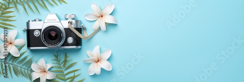 Vintage Camera with Tropical Flowers on Blue Background