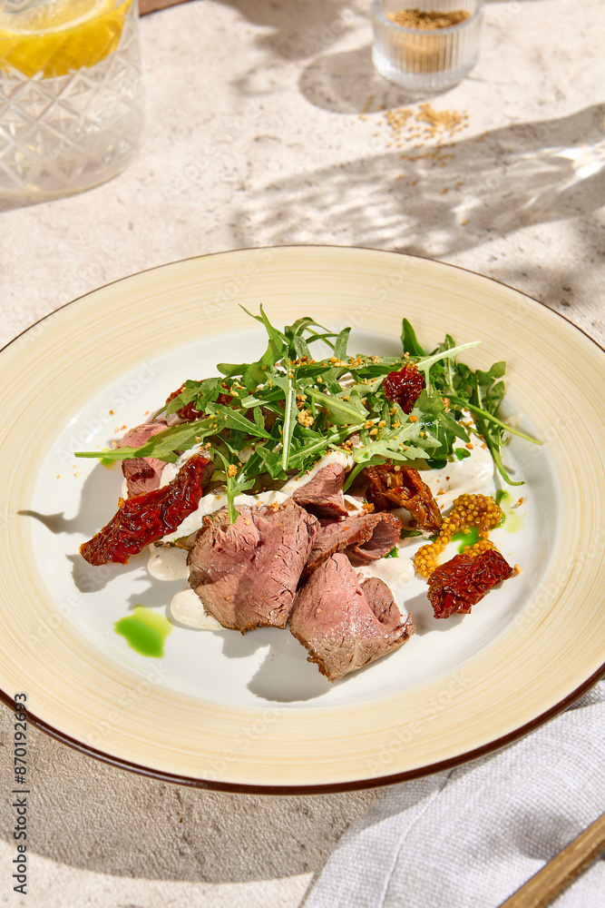 Sunlit Roast Beef with Arugula, Sun-Dried Tomatoes, and Cheese Mousse on Beige Table Sunlit Roast Beef with Arugula, Sun-Dried Tomatoes, and Cheese Mousse on Beige Table