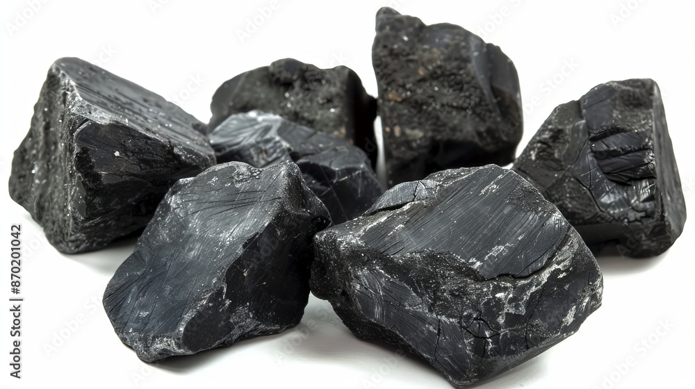 Chunks of Pennsylvania Anthracite stove coal gleam in shades of deep black and slate gray, reflecting the light with a glossy sheen. Chunks of Pennsylvania Anthracite stove coal gleam in shades of deep black and slate gray, reflecting the light with a glossy sheen.
