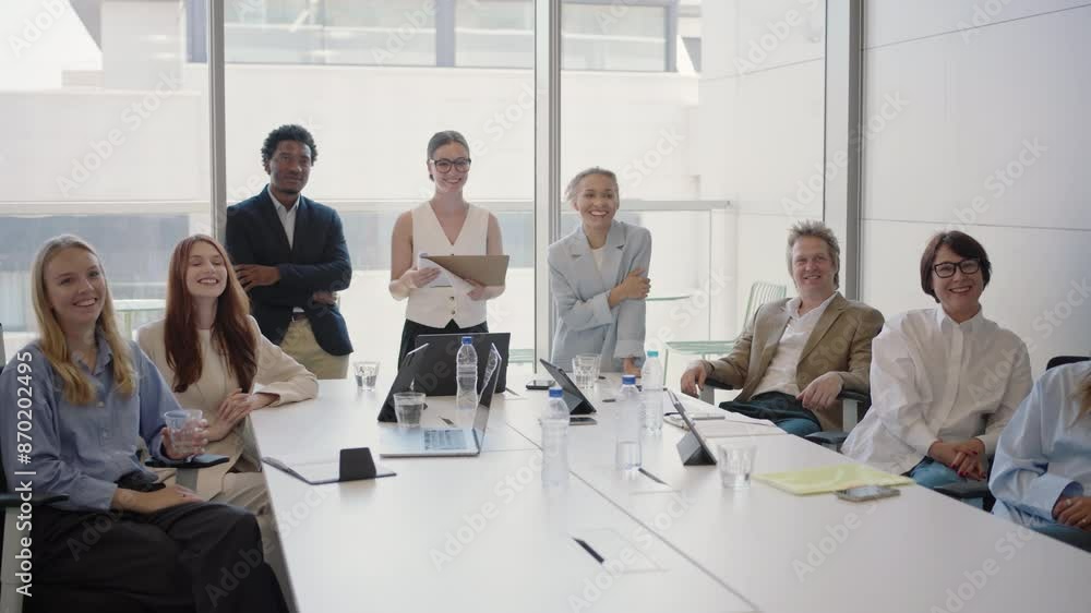 A diverse team of young, successful business people engaged in a collaborative office meeting. The group includes both men and women, highlighting an inclusive and dynamic work environment. A diverse team of young, successful business people engaged in a collaborative office meeting. The group includes both men and women, highlighting an inclusive and dynamic work environment.
