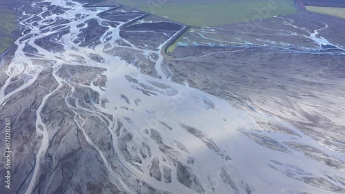 Aerial view of glacier river branches from above, Icelandic glacial river bed and moraine by drone. Climate change and global warming