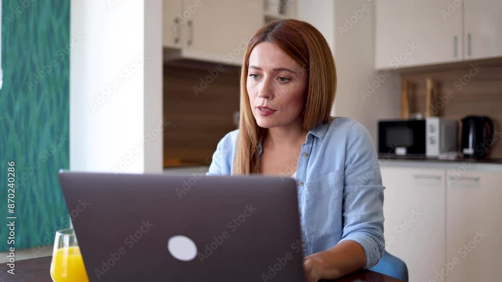 Woman using her computer to surf the net from home Woman using her computer to surf the net from home