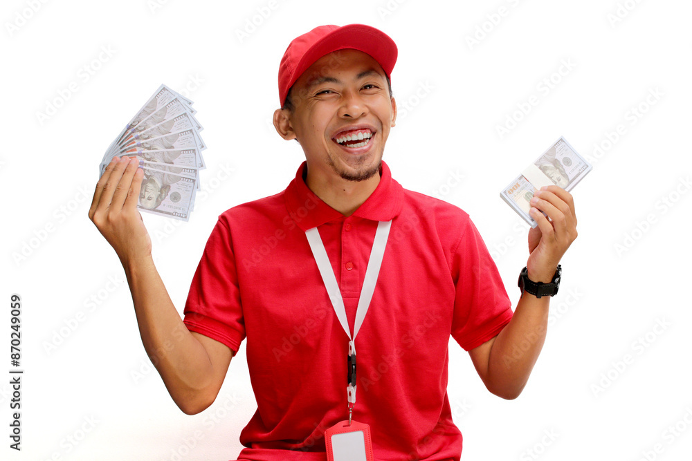 Asian delivery man holds Dollars banknotes in his hand, isolated on white background. Concept of financial success, windfalls, e-commerce, delivery services, and positive financial outcomes Asian delivery man holds Dollars banknotes in his hand, isolated on white background. Concept of financial success, windfalls, e-commerce, delivery services, and positive financial outcomes