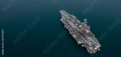 Obraz na płótnie Aerial view military nuclear ship navy ship carrier full loading fighter jet aircraft, Aircraft carrier nuclear warship battleship, Military nuclear ship on the ocean. w salonie