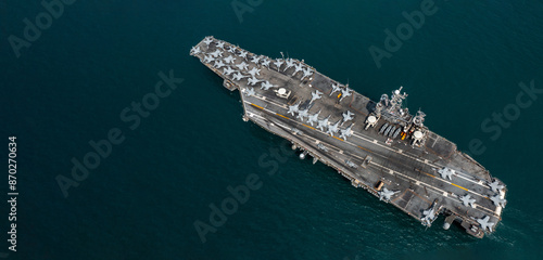 Obraz na płótnie Aerial view military nuclear ship navy ship carrier full loading fighter jet aircraft, Aircraft carrier nuclear warship battleship, Military nuclear ship on the ocean. w salonie