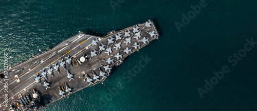 Obraz na płótnie Aerial view military nuclear ship navy ship carrier full loading fighter jet aircraft, Aircraft carrier nuclear warship battleship, Military nuclear ship on the ocean. w salonie