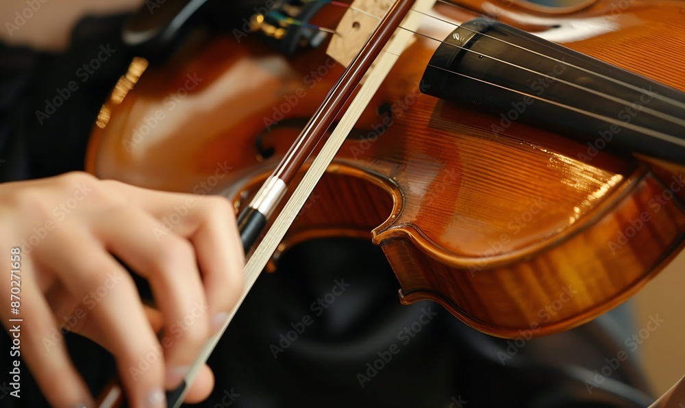 Fototapeta premium Close-Up of a Violinist's Hand on the Bow