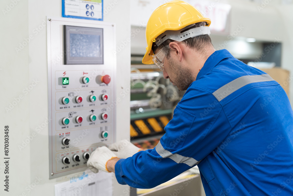 Male electrician engineer control electric system in industry factory. Factory male worker at work in the industry factory, work with CNC machine. Factory engineer male worker maintaining machine Male electrician engineer control electric system in industry factory. Factory male worker at work in the industry factory, work with CNC machine. Factory engineer male worker maintaining machine