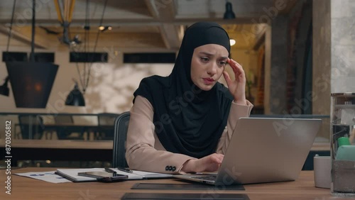 Displeased sad worker muslim islamic businesswoman in hijab upset online project mistake Arabian man businessman boss coach come help trainee solve problem excited happy woman working laptop in office