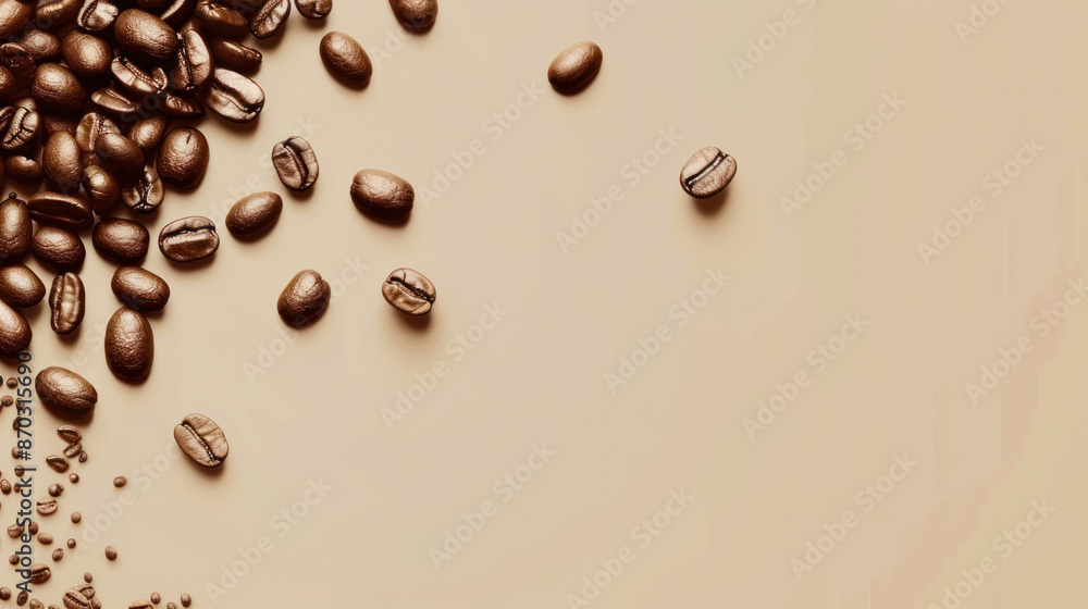 A close-up image of coffee beans scattered on a beige background A close-up image of coffee beans scattered on a beige background
