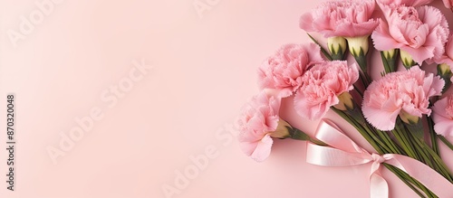 Top view of a bouquet of carnations and a gift box on a pink background for Mother's Day, weddings, and Valentine's Day, with space for adding your own image. with copy space image