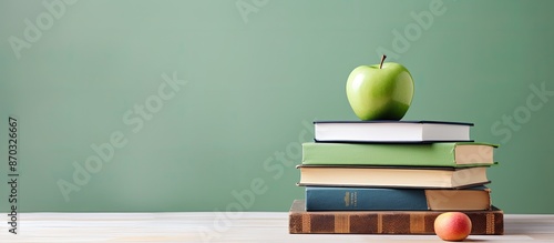 Green apple and stack of bo...