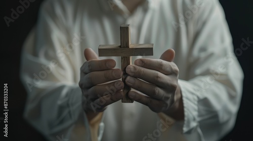 The hands holding a cross photo