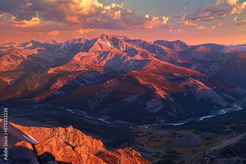 /imagine A dramatic mountain range during the golden hour, with the sun casting long shadows and illuminating the peaks in warm hues of orange and pink, while a river winds through the valley below.