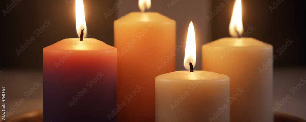 Four burning candles on a tabletop Four burning candles on a tabletop