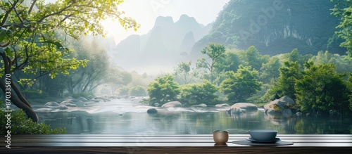 Scenic garden landscape with a serene river and mountain in the background, featuring an empty dining table with copy space image.
